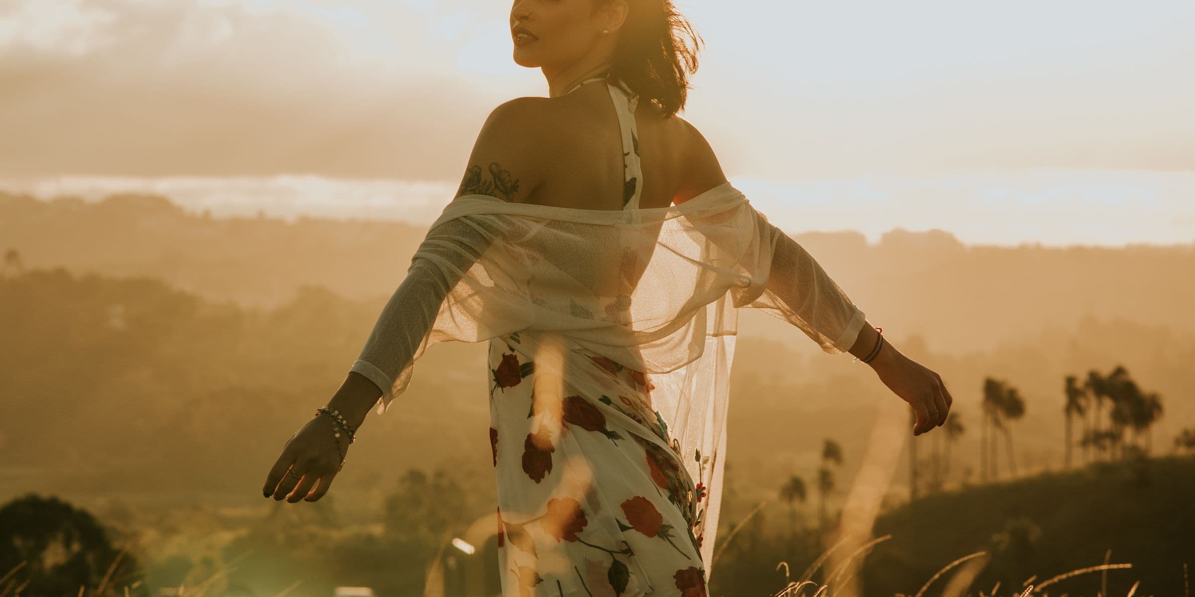 Woman enjoying a golden-hour landscape